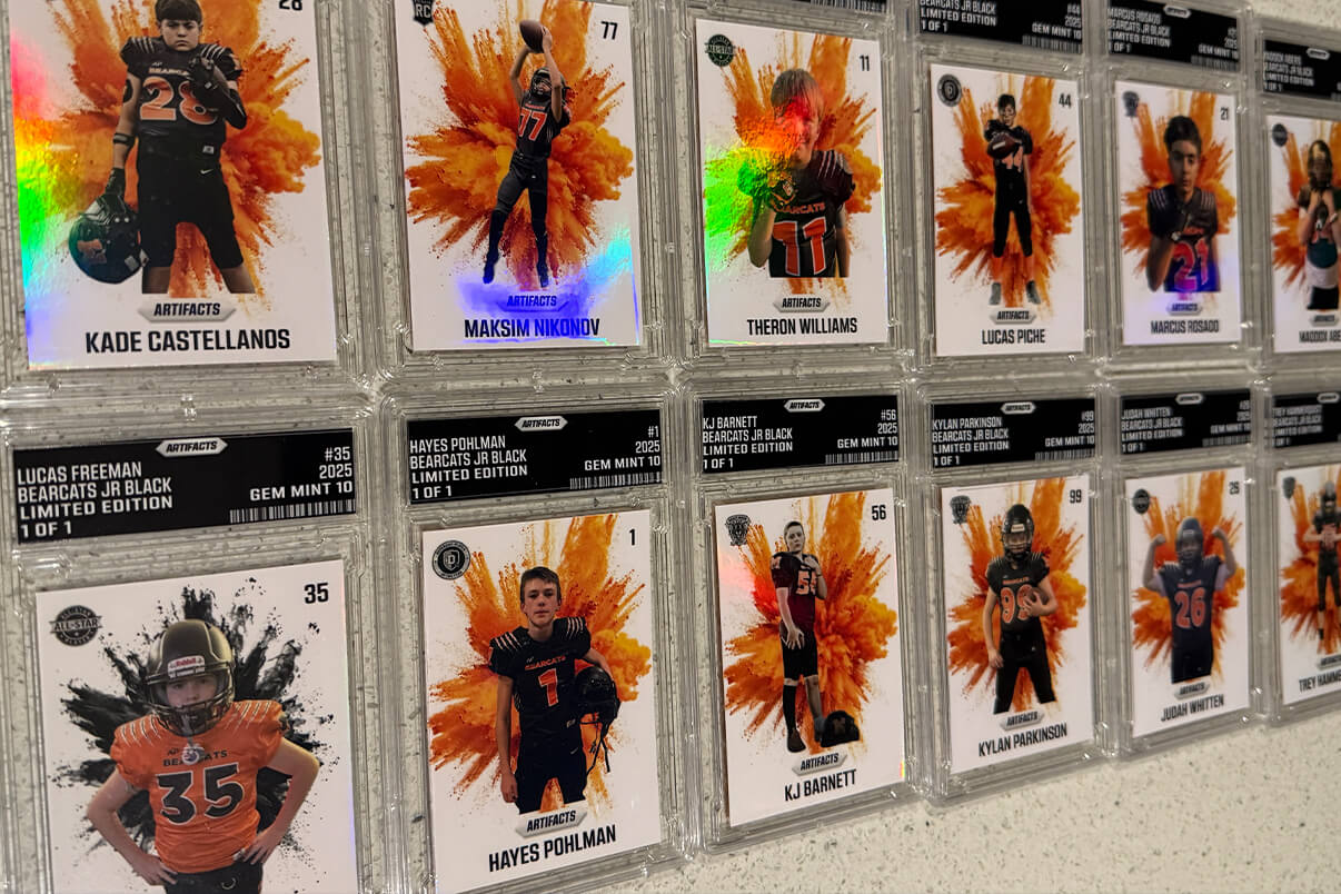 Coach and kids holding trading cards